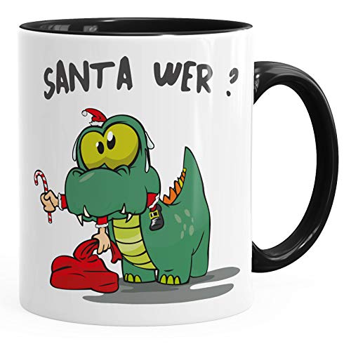 MoonWorks® Kaffee-Tasse Dinosaurier frisst Santa Claus Spruch Santa Wer? Weihnachtsmann Weihnachtstasse lustig schwarz Keramik-Tasse von MoonWorks
