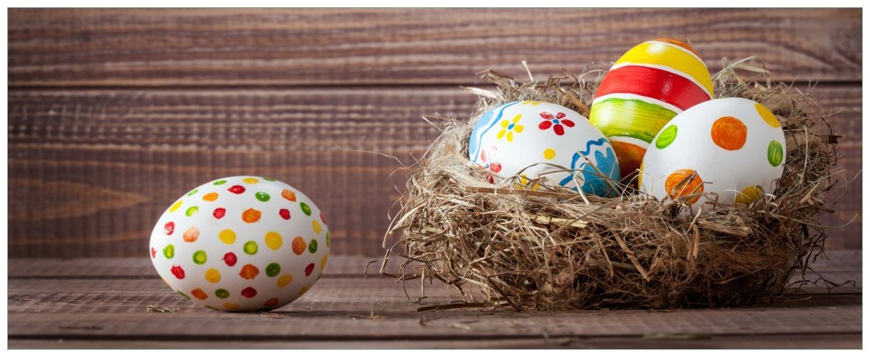 Wallario Poster, Bunte bemalte Eier an Ostern im Vorgelnest vor hölzerner Wand, in verschiedenen Ausführungen von Wallario